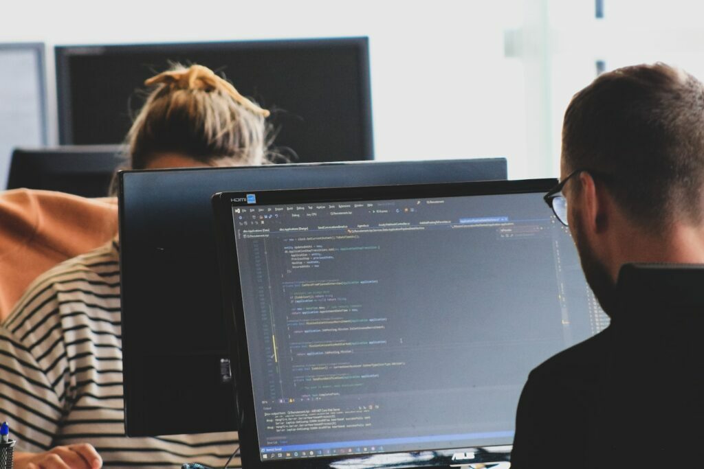 G4F woman in black shirt sitting beside black flat screen computer monitor
